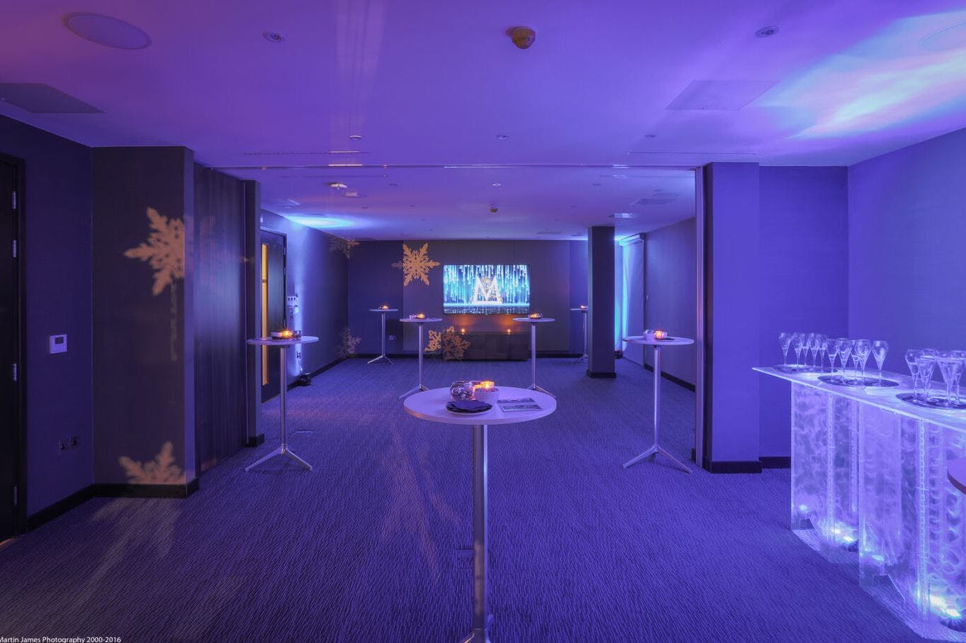 Sleek modern event space with blue lighting for networking and cocktail receptions.