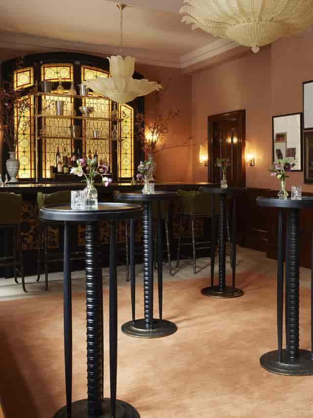 Sophisticated event space in The NoMad London with elegant floral arrangements for cocktail receptions.