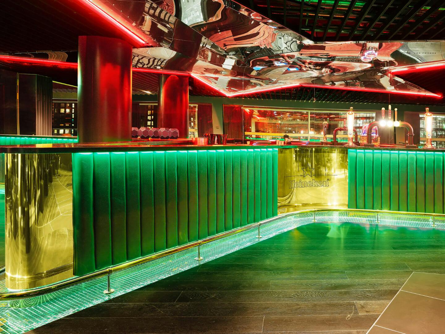 Heineken Sky Lounge at AO Arena, modern bar with green and gold accents for upscale events.