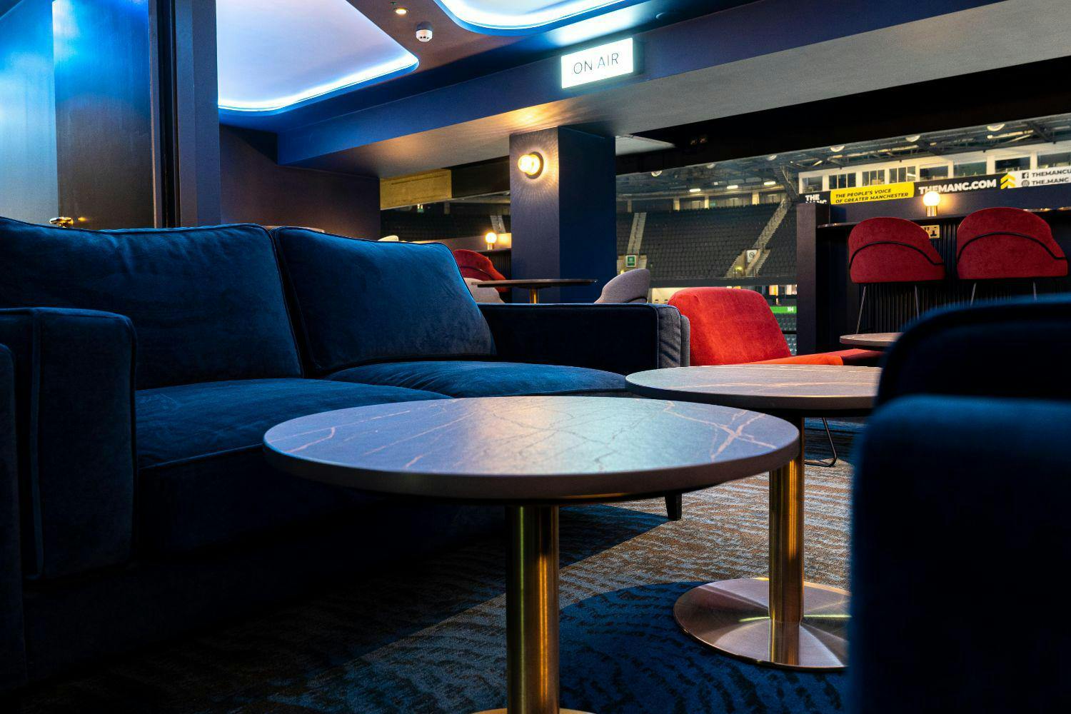 Luxury Suites lounge at AO Arena with plush sofas for networking events and gatherings.