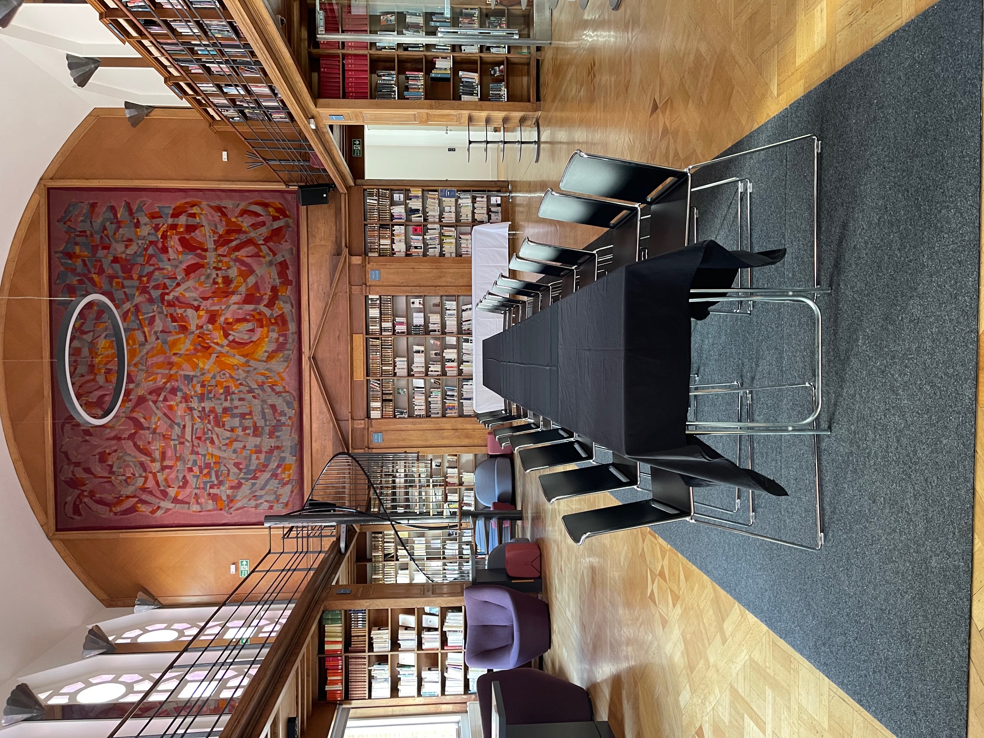 Art Deco library meeting space with elegant table, ideal for workshops and gatherings.
