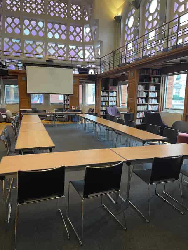 Art Deco library meeting space with U-shaped table for workshops and brainstorming.