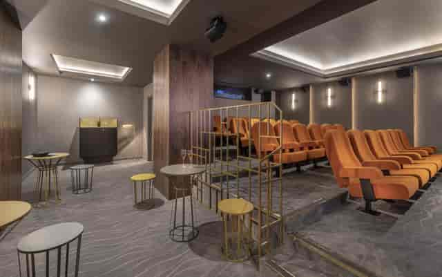 Ciné Lumière 2: modern event space with tiered seating for intimate gatherings and presentations.