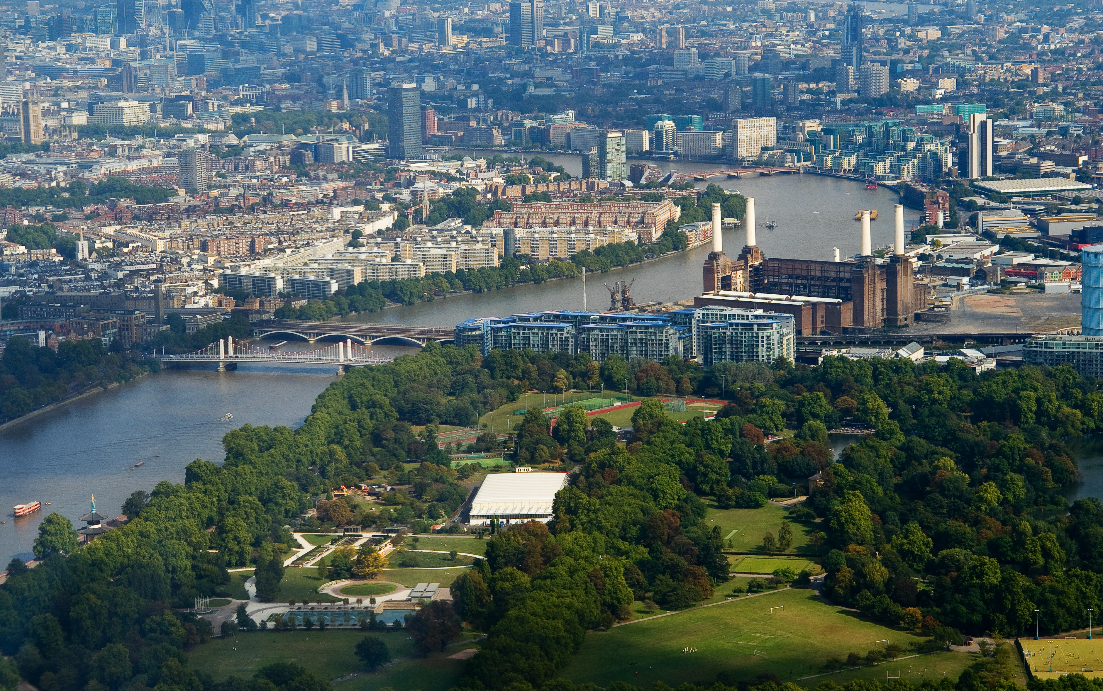 Aerial view of Evolution London, showcasing vibrant cityscape and lush park for summer events. - Banner