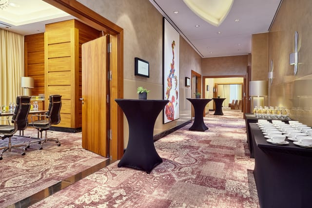 Modern event space in JW Marriott Frankfurt with stylish decor and networking tables.