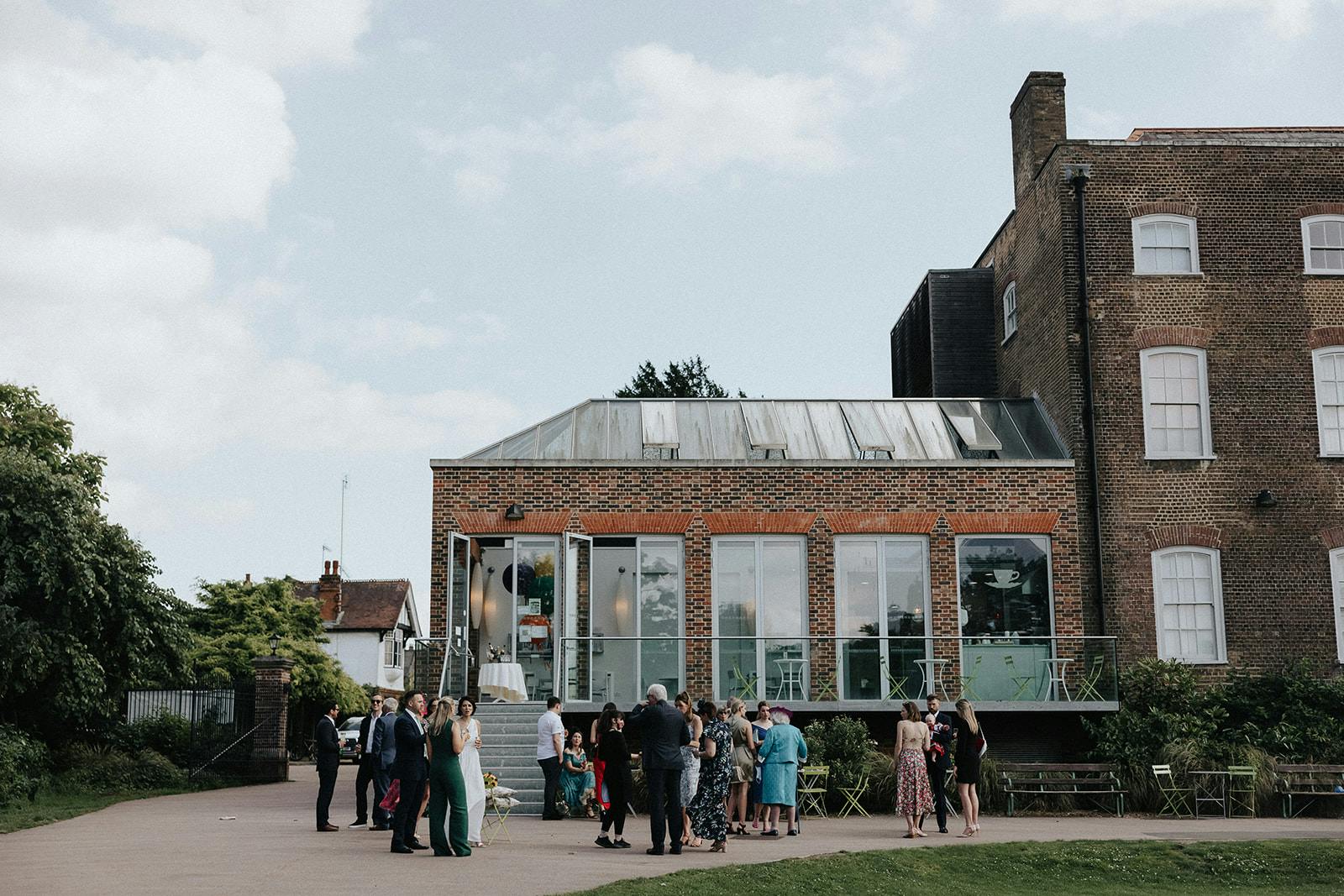 Outdoor gathering at Glasshouse, modern architecture, ideal for events and networking.