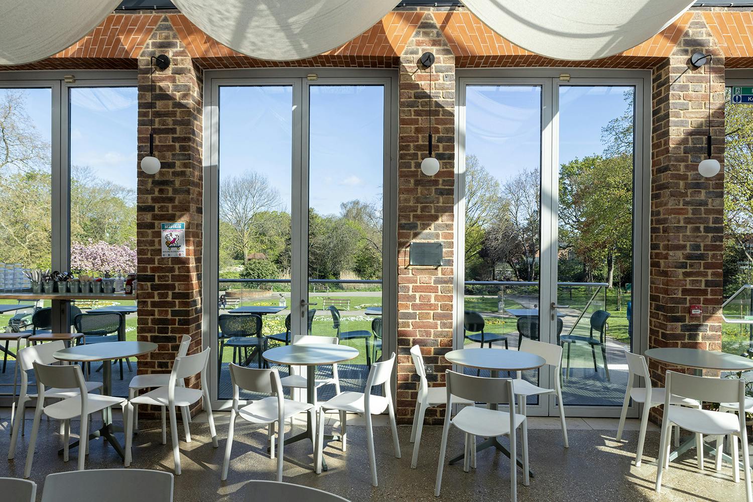 Bright event space with large windows at Glasshouse, ideal for meetings and gatherings.