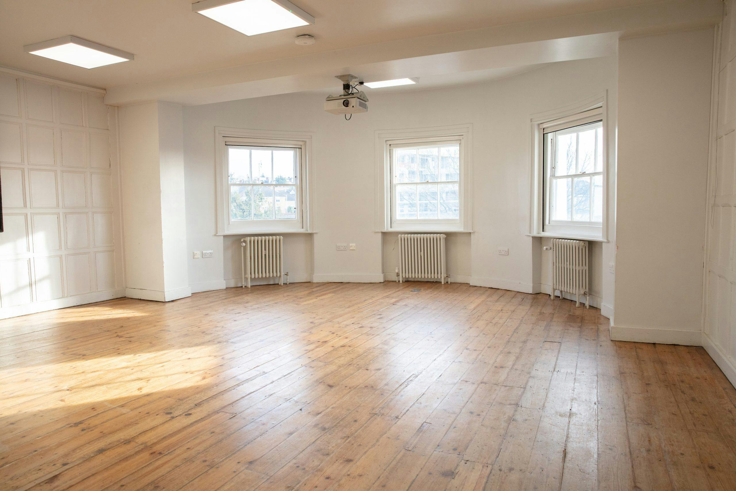 Acanthus event space with natural light and wooden flooring for meetings and workshops.