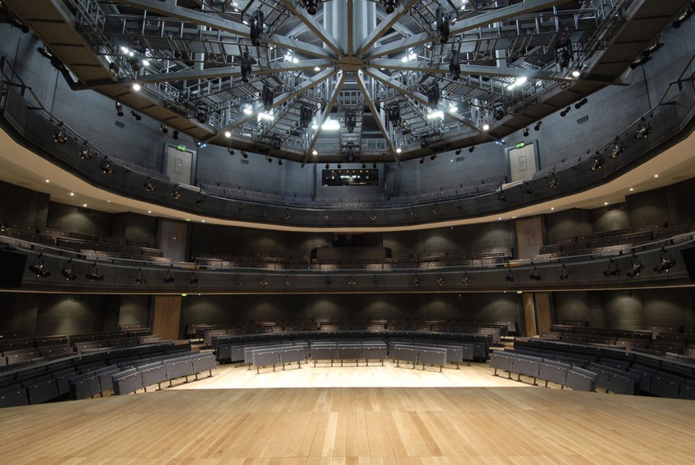Modern Rose Theatre auditorium with tiered seating, ideal for conferences and performances. - Banner