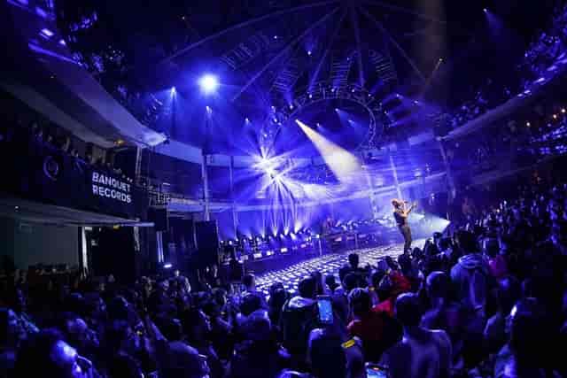 Live event in Rose Theatre's Main Auditorium with performer and vibrant lighting.
