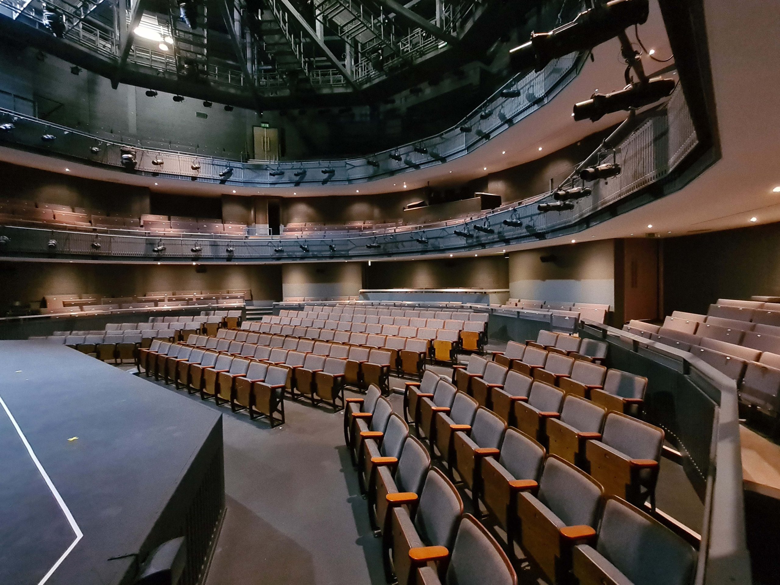 Main Auditorium in Rose Theatre with tiered seating for conferences and performances. - Banner
