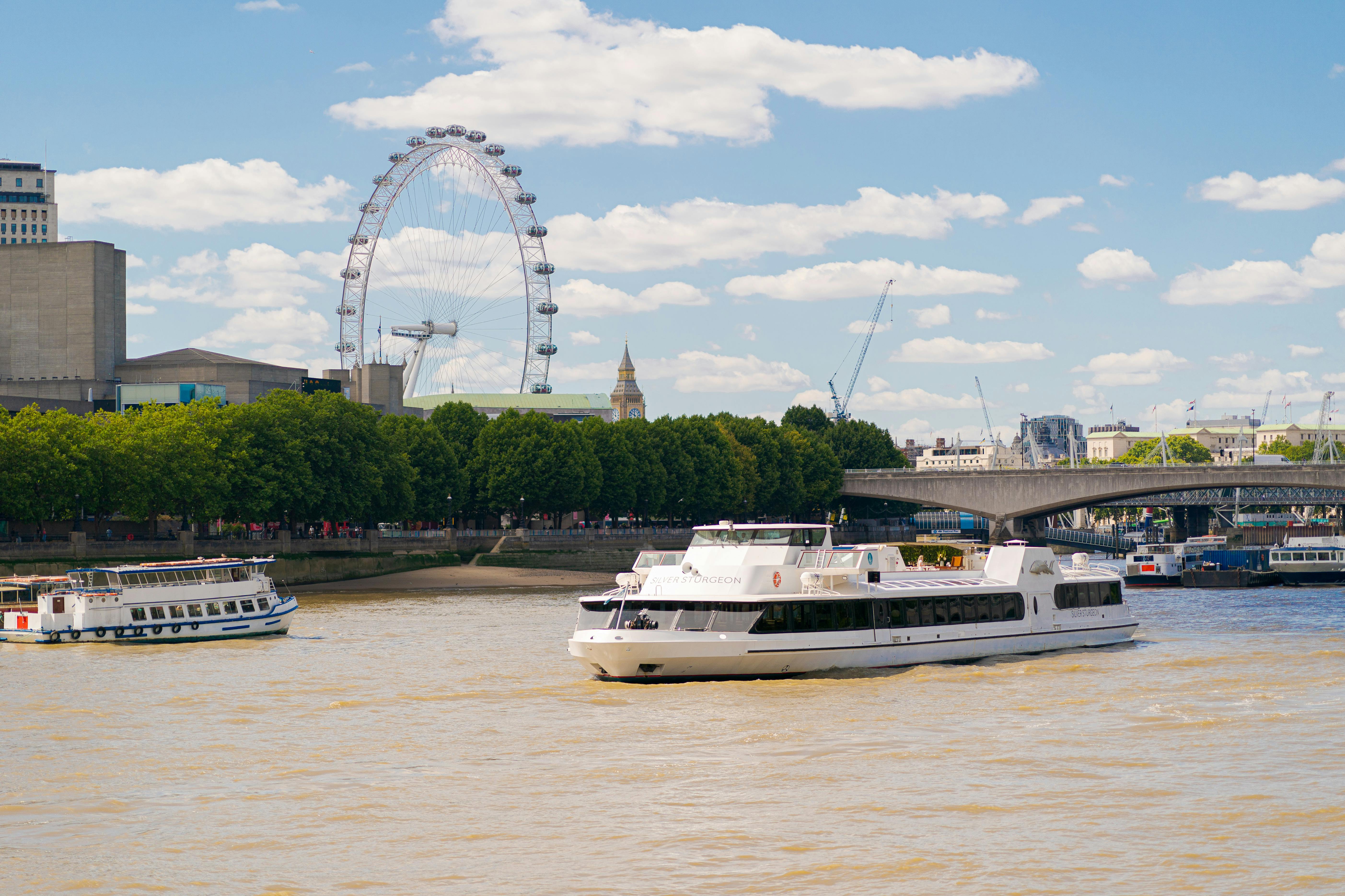 Silver Sturgeon event boat on River Thames with London Eye, perfect for corporate gatherings.