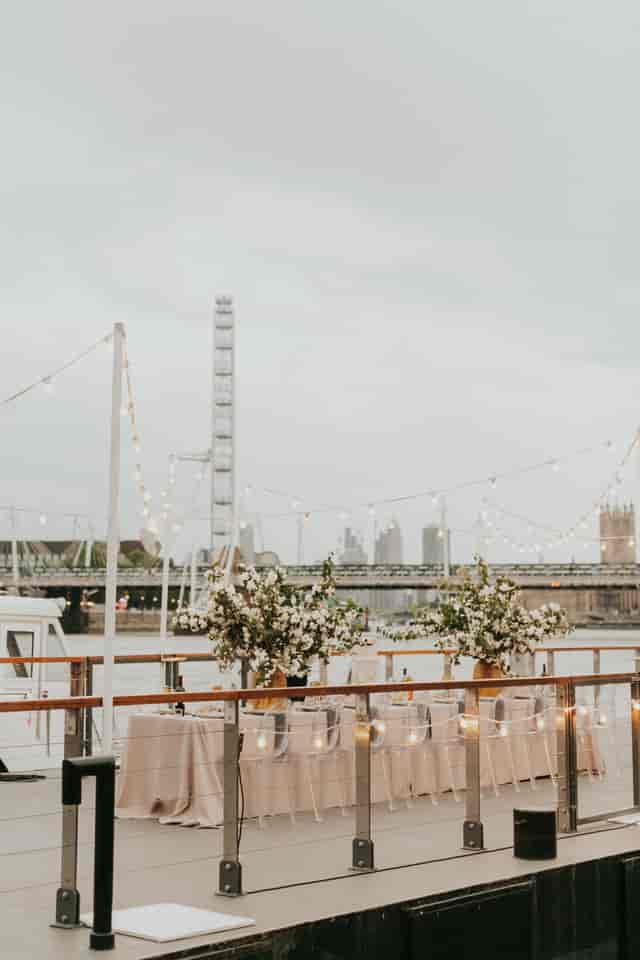 Woods Quay outdoor event space with floral decor and London Eye backdrop.