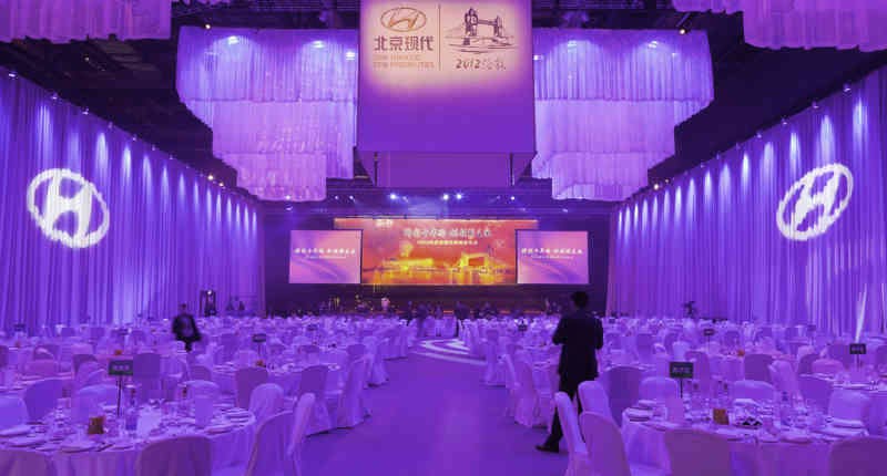 Elegant Banqueting House in ExCeL London, set for corporate events with purple lighting.