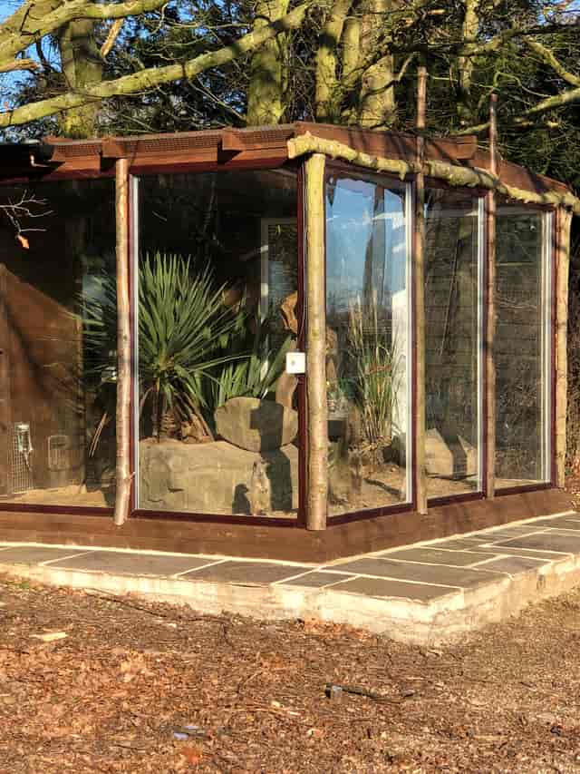 Unique venue with glass panels and greenery for creative meetings and events.