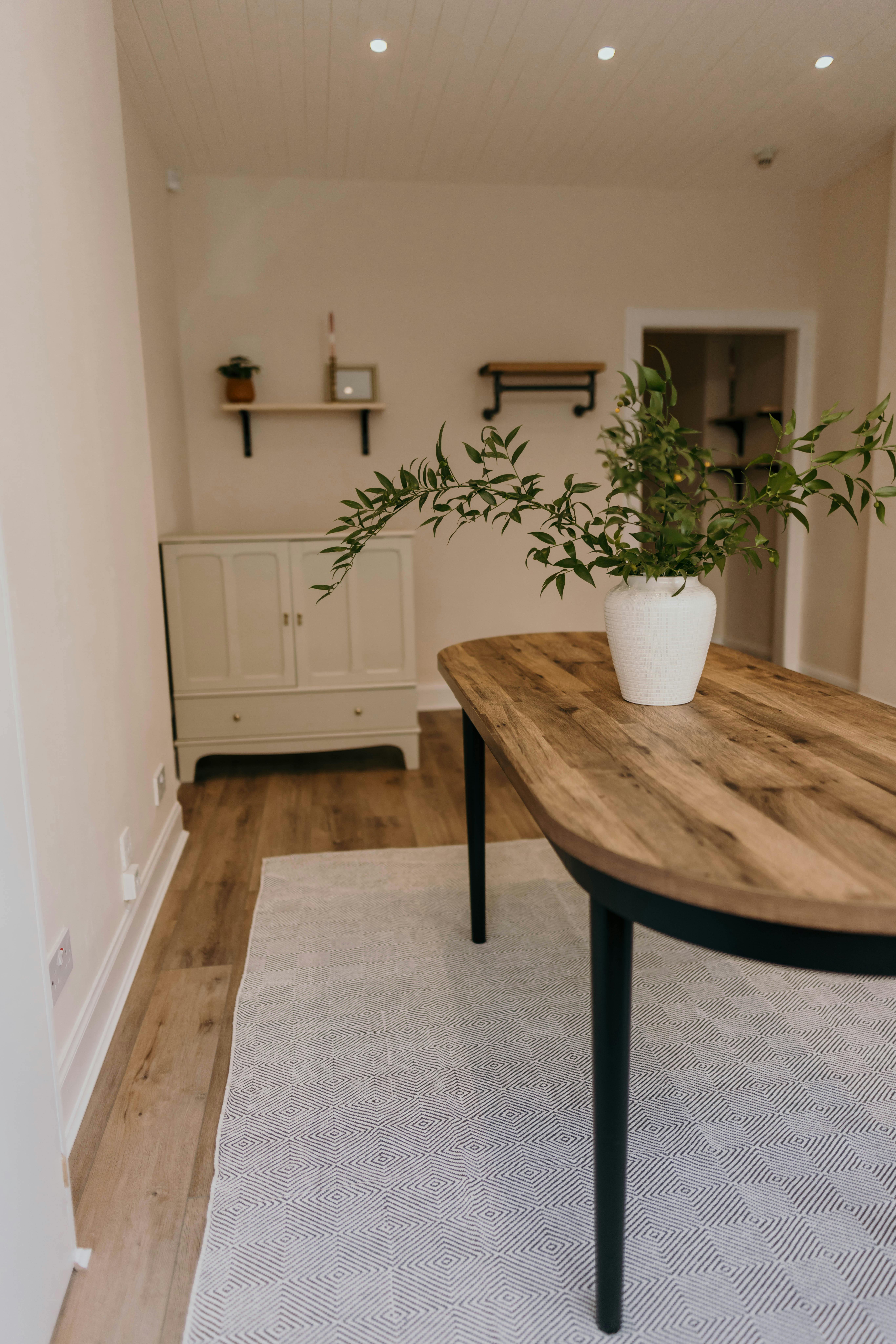 Rustic wooden table in a minimalist meeting space for creative collaboration.