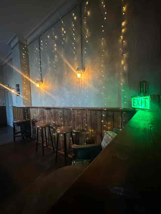 Cozy billiard room with warm lighting, perfect for intimate gatherings and events.