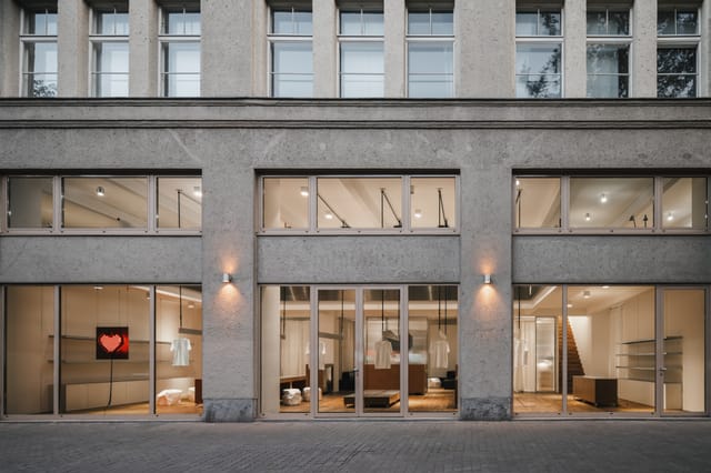 Modern venue with large glass windows, perfect for corporate meetings and social events.