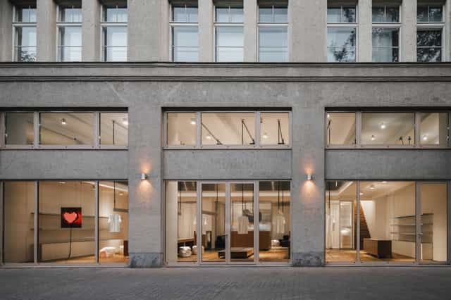 Modern venue with large glass windows, perfect for corporate meetings and social events.