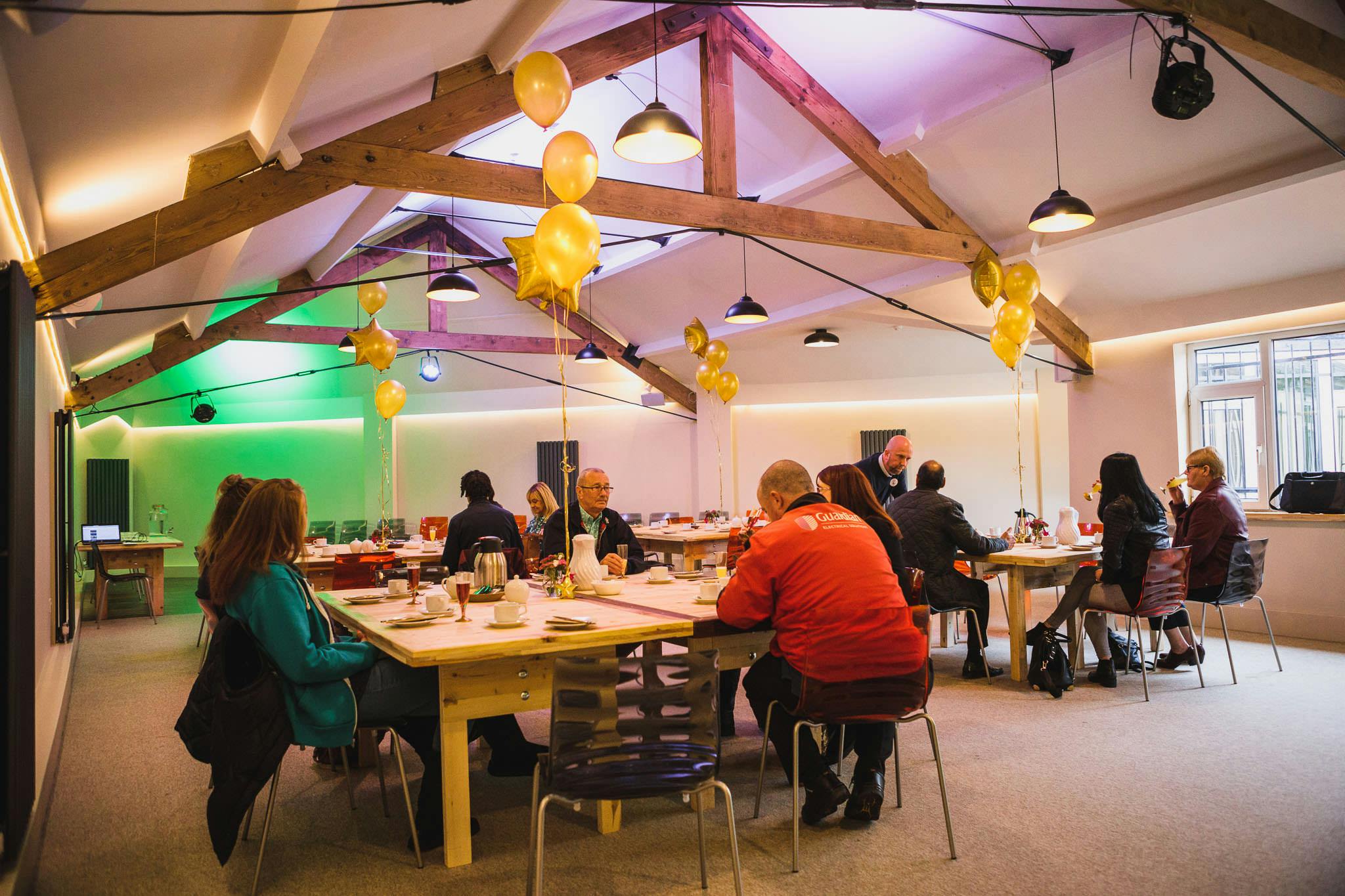 Modern meeting space with yellow balloons for workshops and team-building events.