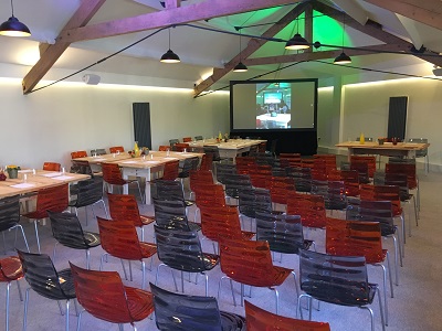 Modern meeting space with colorful chairs for presentations and group discussions. - Banner
