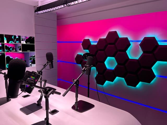 Redbridge Podcast Studio with vibrant lighting, ideal for hybrid events and presentations.
