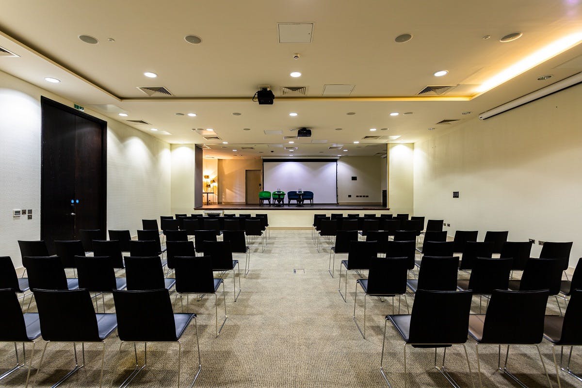 Meeting space with black chairs for conferences at Guildford Harbour Hotel.