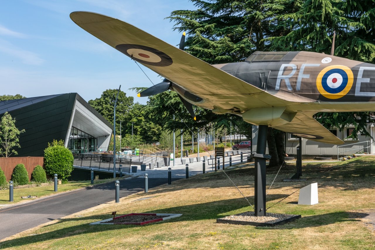 Visitor Center at Battle of Britain Bunker with vintage aircraft, ideal for corporate events. - Banner