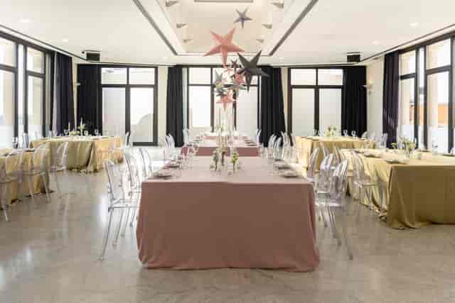 Elegant event space with pastel linens and floral centerpieces at Circulo De Bellas Artes.