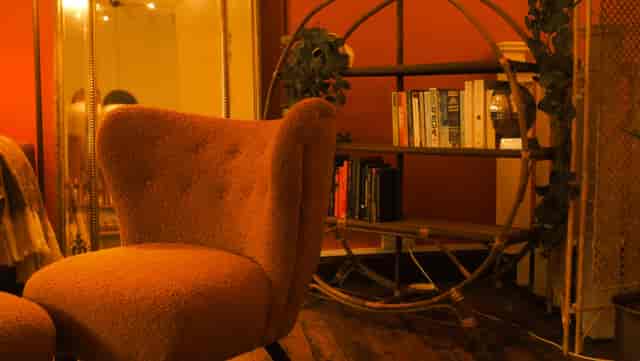 Cozy Orange Room with warm armchair, ideal for meetings and brainstorming sessions.
