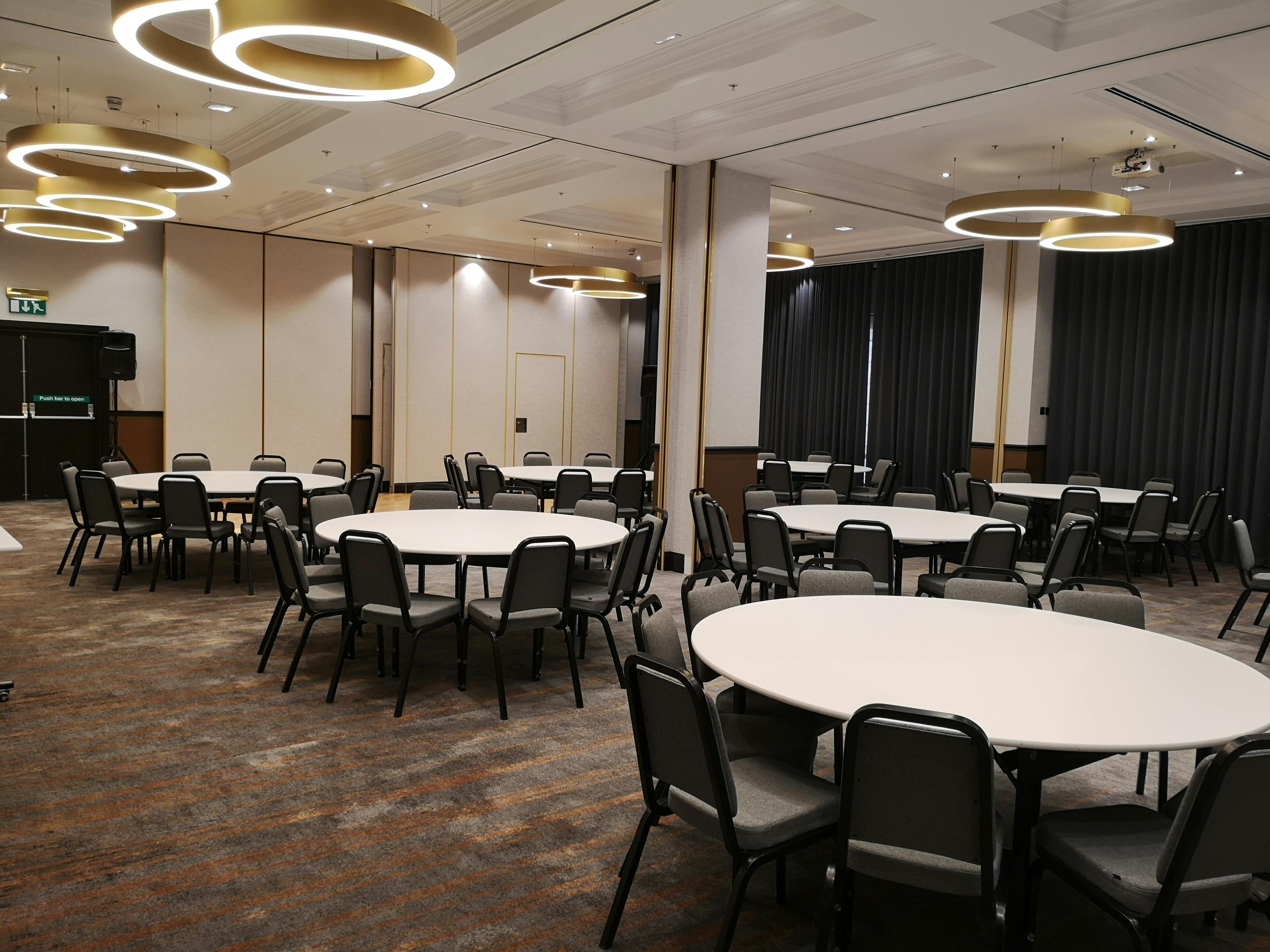 Westmacott Suite at London Marriott: versatile event space with round tables for networking.