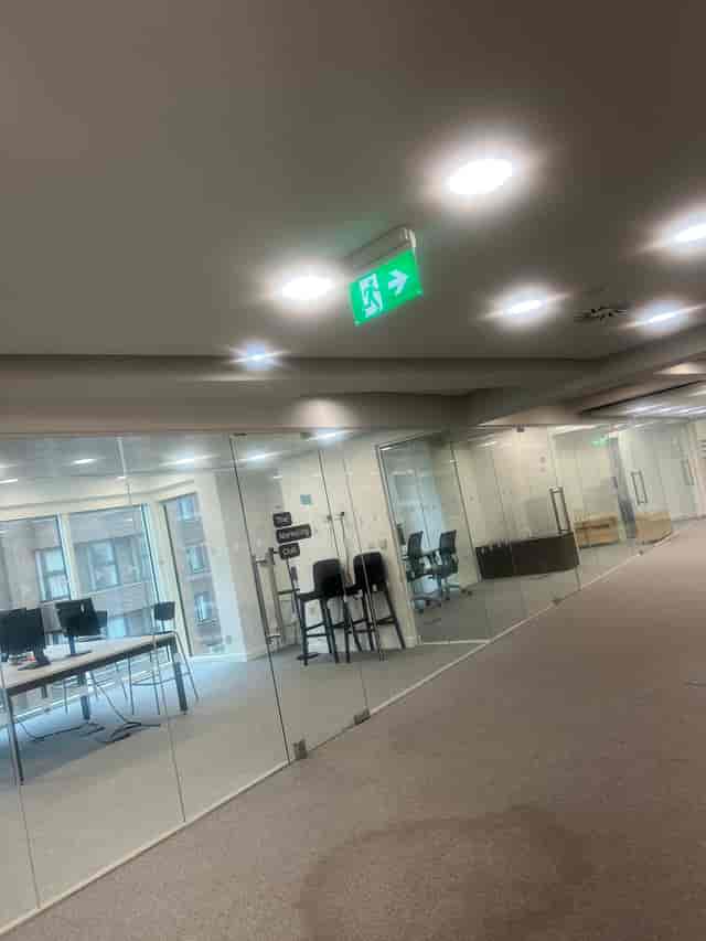 Modern sapphire meeting space with glass walls, perfect for events and collaboration.