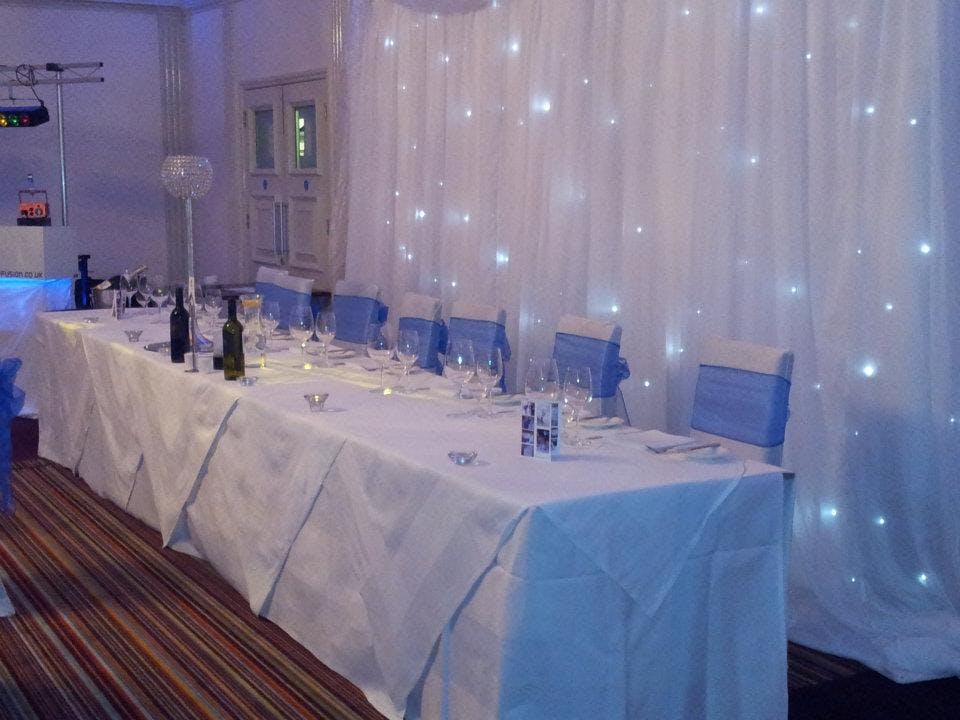 Elegant dining table with blue accents in ABode Hotel's County Room for formal events.