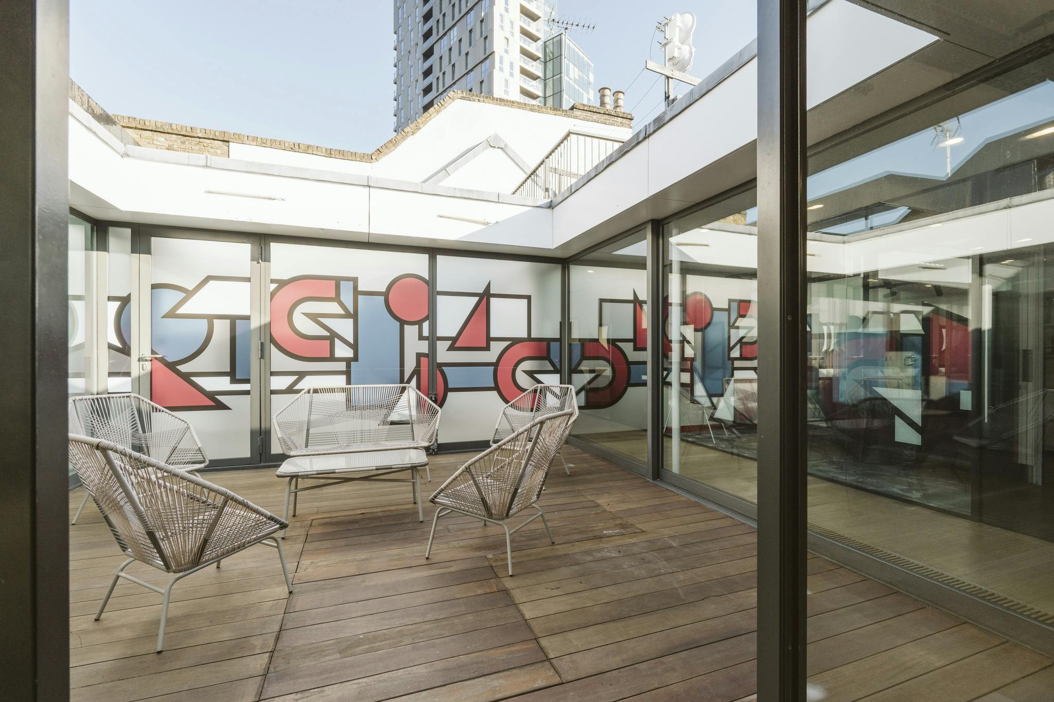 Modern meeting space with vibrant mural at Sky Guild Gaming Centre for creative events.