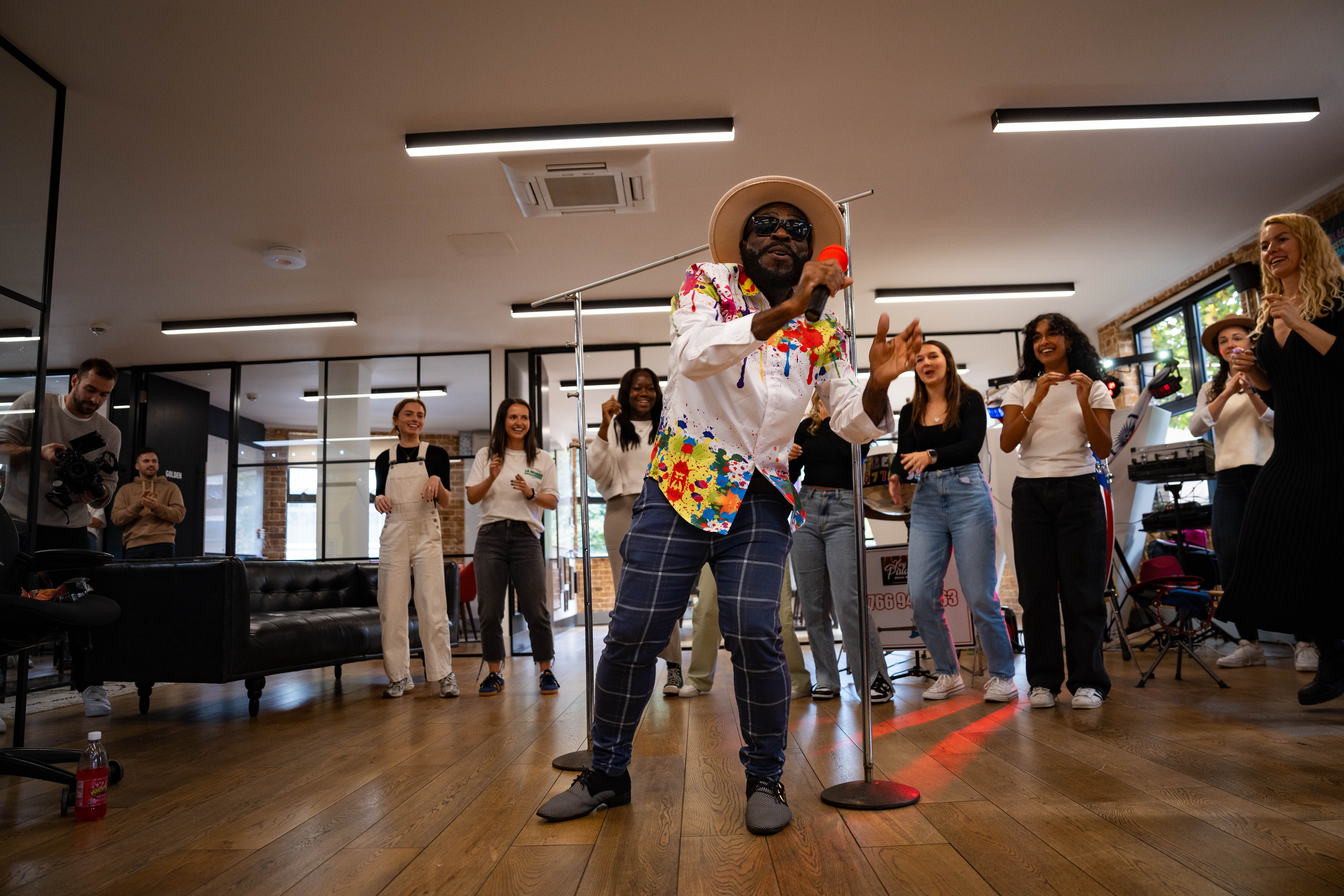 Lively performer engaging audience at EC1 Campus event for team-building activities.