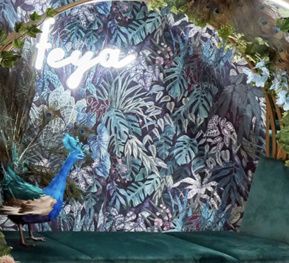 Feya Knightsbridge with peacock and tropical foliage, perfect for events and branding.