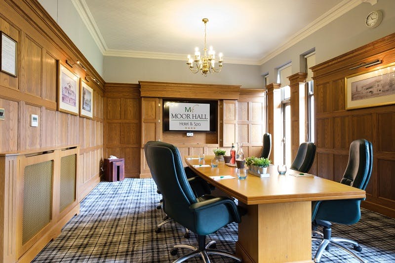 Aston meeting room at Moor Hall Hotel, featuring a large wooden table for executive meetings.