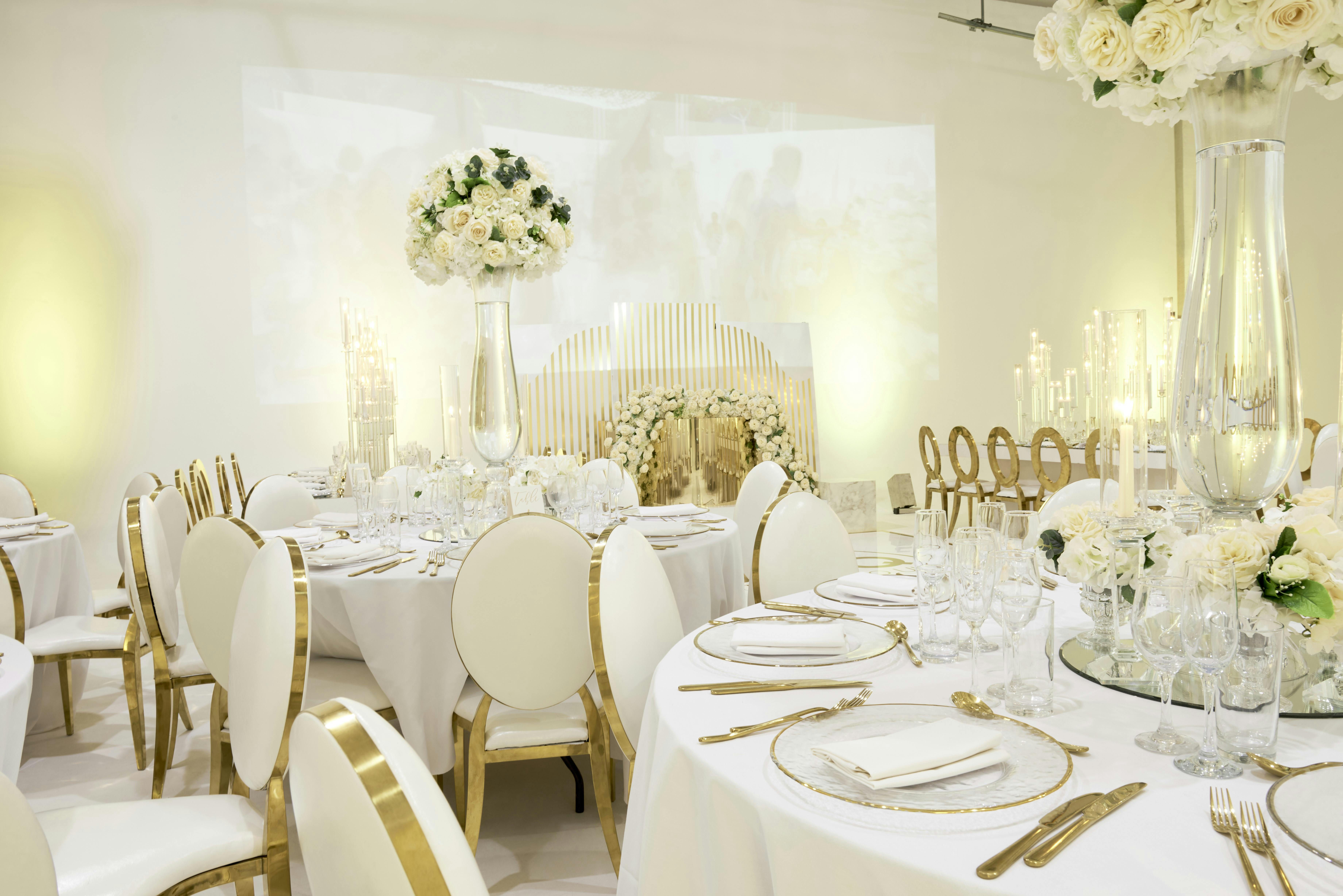 Elegant event space with round tables, ideal for weddings and corporate galas.