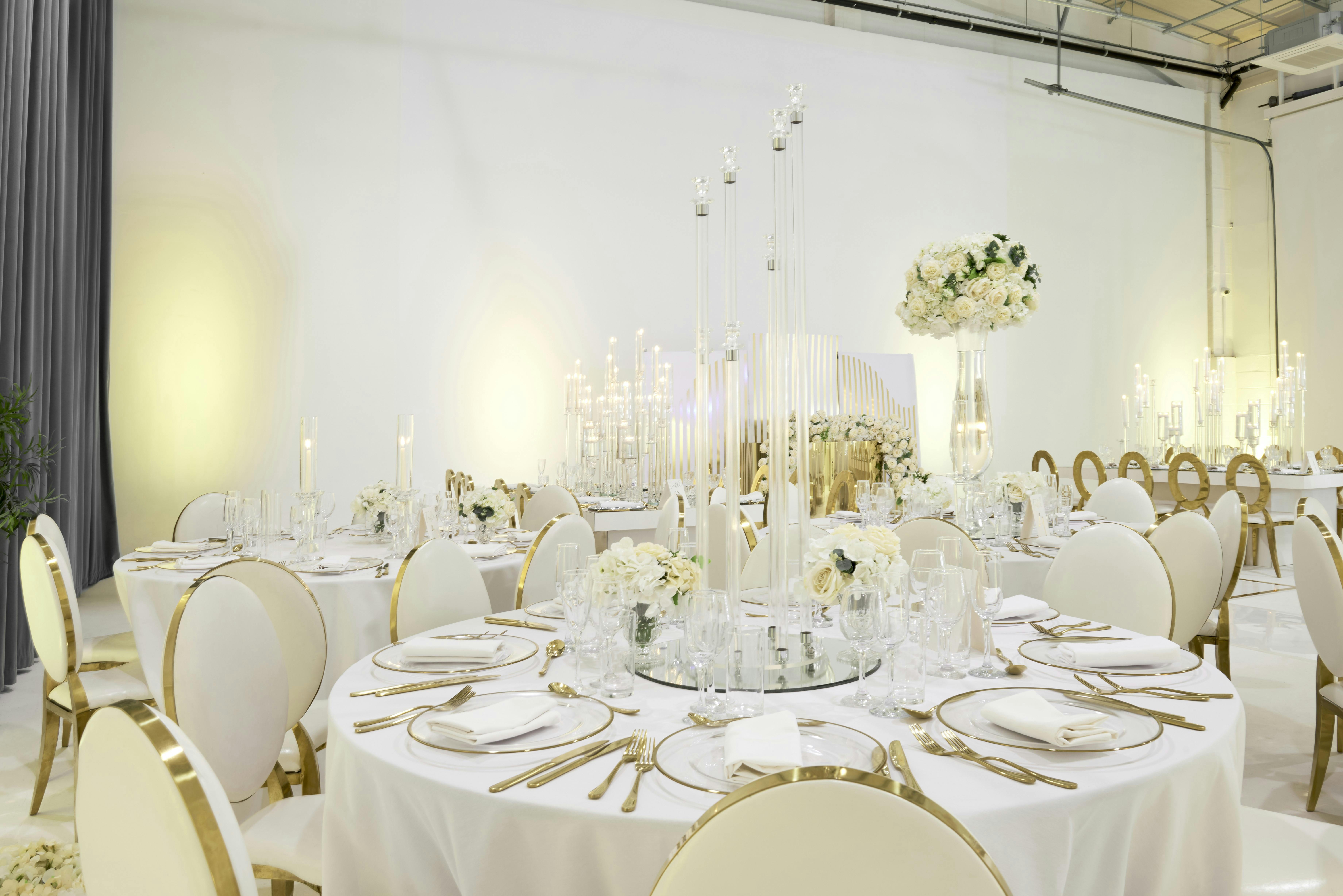 Elegant event space with round tables, ideal for weddings and corporate events.