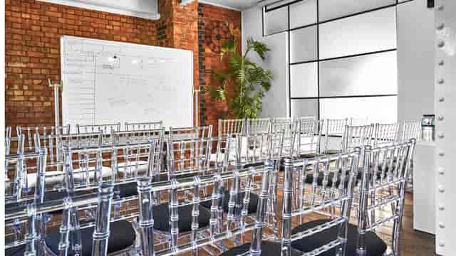 Modern meeting space with acrylic chairs for corporate events and workshops.
