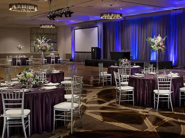 Centennial Ballroom with elegant round tables, perfect for corporate events and weddings.
