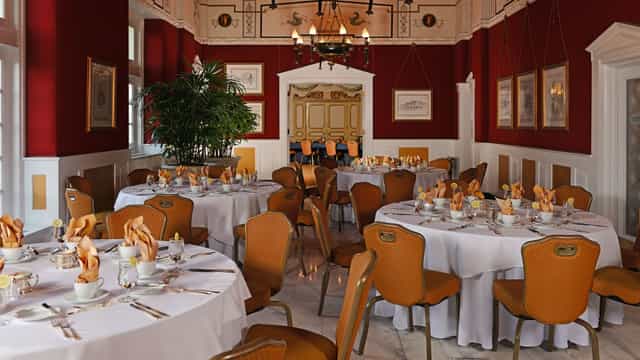 Elegant dining room with round tables, ideal for upscale events at The Broadmoor.