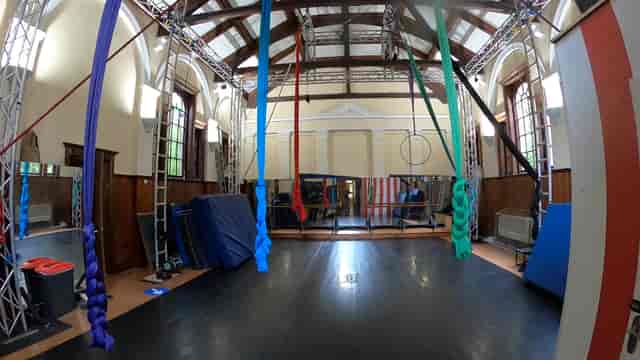 Versatile event space with aerial silks in West Midlands Circus Centre for fitness workshops.