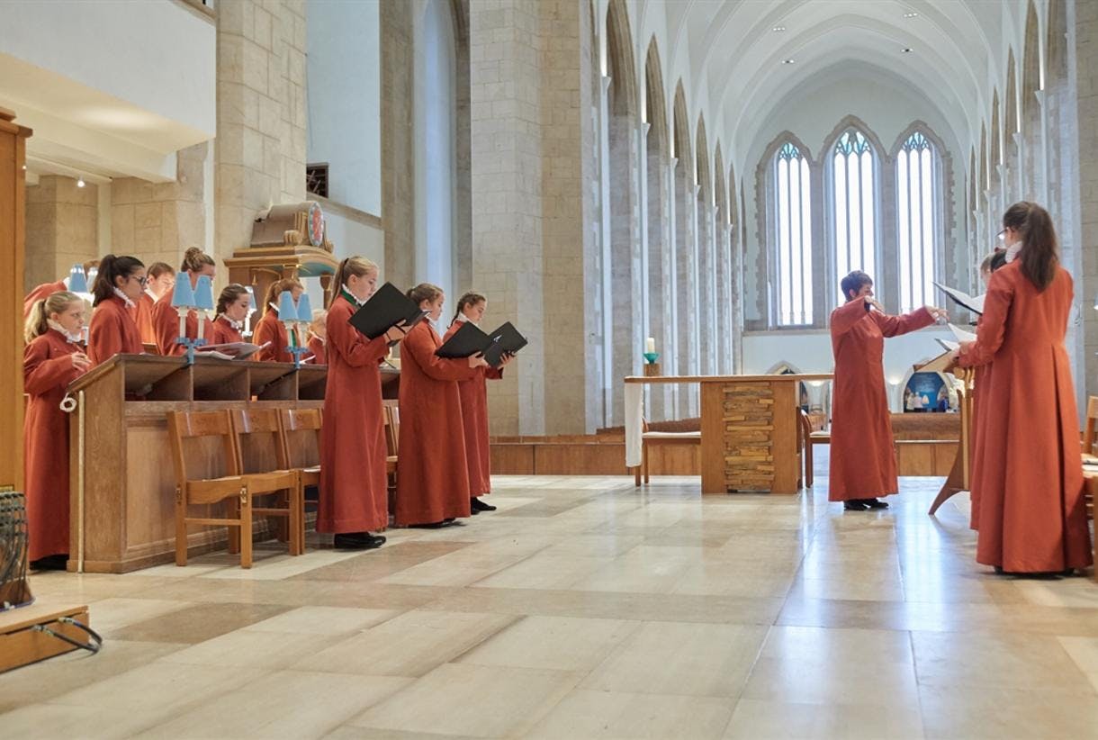 Choir performing in Guildford Cathedral's elegant chapel, perfect for events and rehearsals.