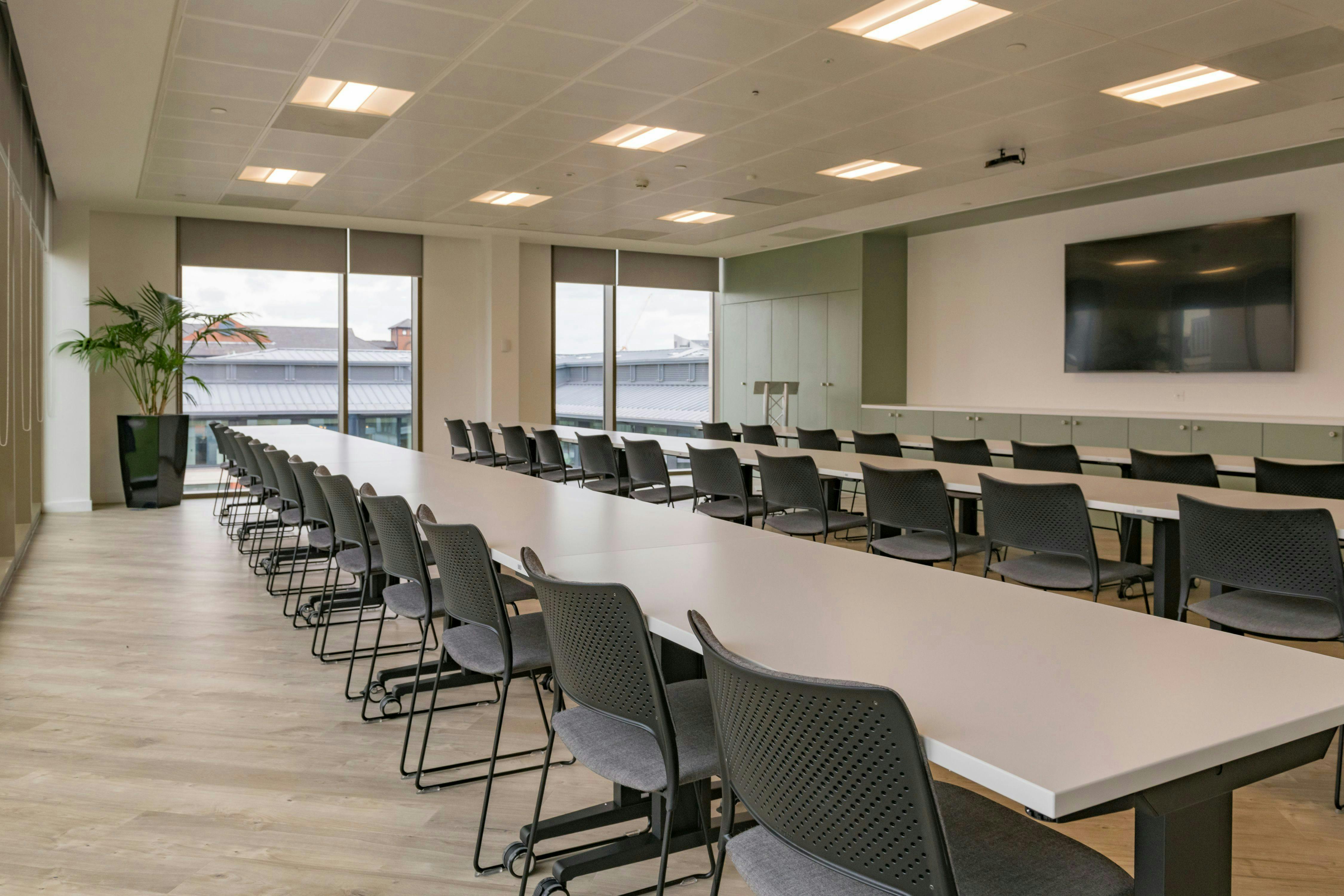 Modern conference room with long table, ideal for corporate meetings and workshops.