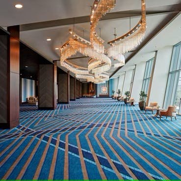 Spacious Houston Ballroom with elegant chandeliers, perfect for conferences and events.