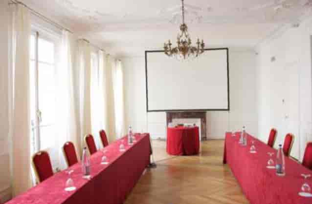 Elegant meeting room with red tablecloths for corporate events and workshops.