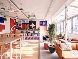 Vibrant meeting space with colorful art, ideal for workshops and brainstorming sessions.