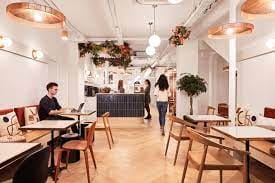 Modern café with flexible seating, ideal for networking events and informal meetings.