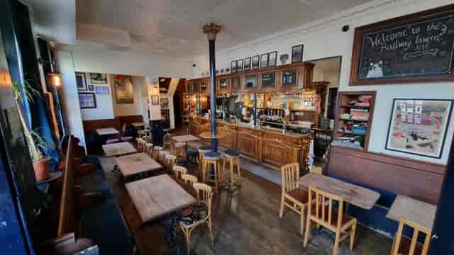 Cozy Railway Tavern N16 with warm wooden bar, ideal for networking events.